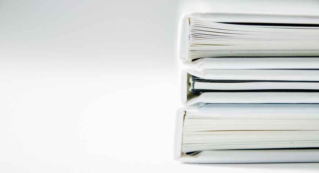 a stack of white books set against a white background